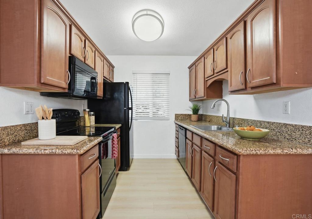 4455 Home Avenue, Unit 2 San Diego, CA 92105 - Photo 12 of 28 a kitchen with stainless steel appliances granite countertop a sink stove refrigerator and cabinets