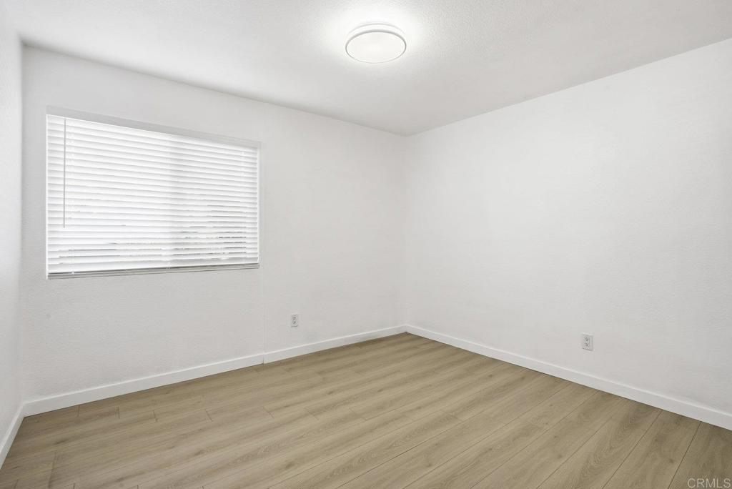 4455 Home Avenue, Unit 2 San Diego, CA 92105 - Photo 14 of 28 wooden floor in an empty room with a window