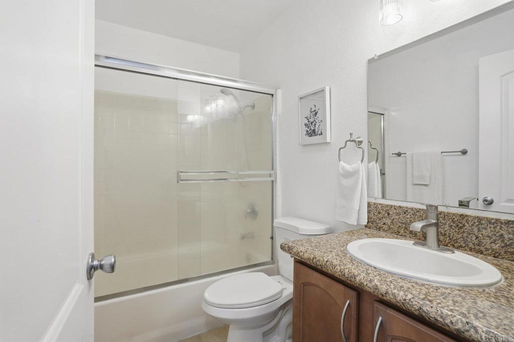 4455 Home Avenue, Unit 2 San Diego, CA 92105 - Photo 17 of 28 a bathroom with a granite countertop sink toilet and shower