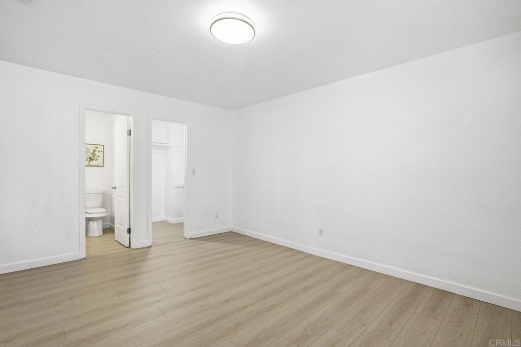 4455 Home Avenue, Unit 2 San Diego, CA 92105 - Photo 19 of 28 an empty room with wooden floor and white walls
