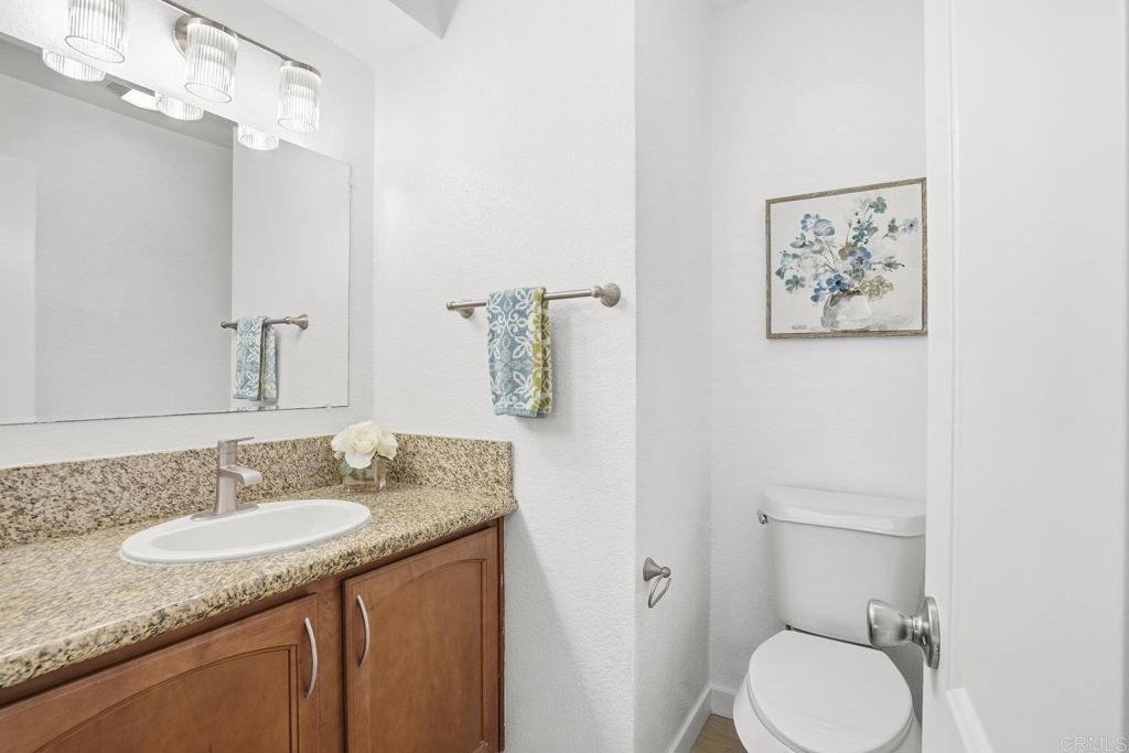 4455 Home Avenue, Unit 2 San Diego, CA 92105 - Photo 20 of 28 a bathroom with a granite countertop sink toilet and a mirror
