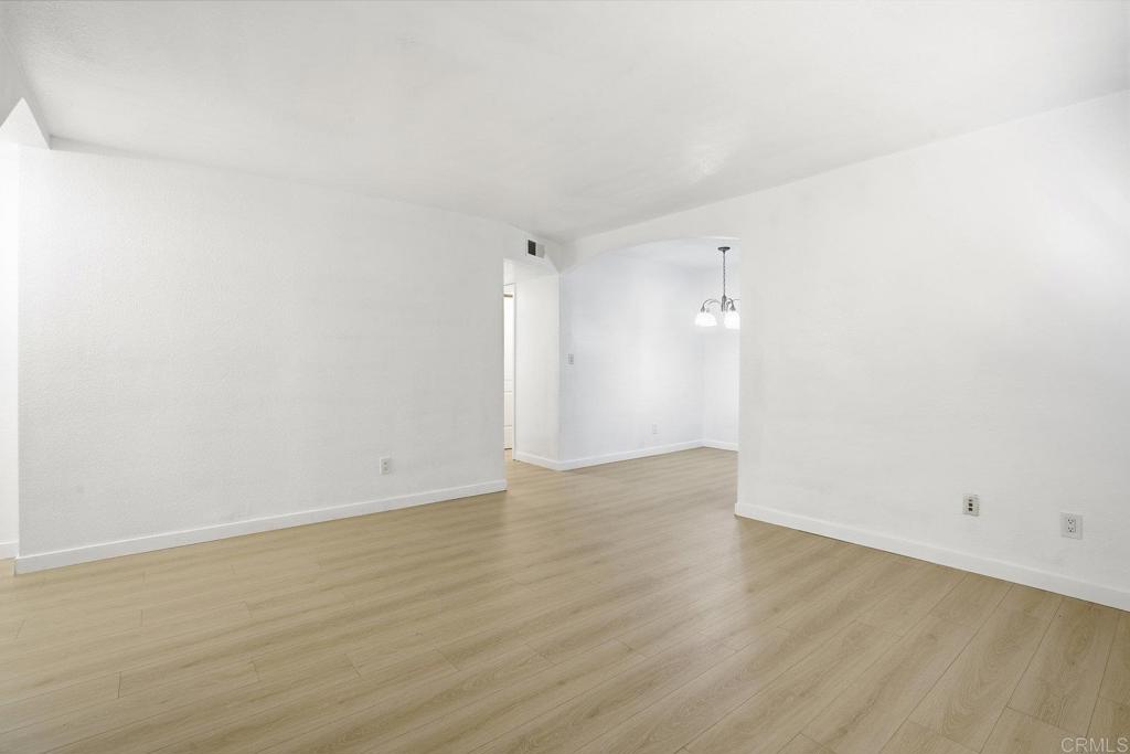4455 Home Avenue, Unit 2 San Diego, CA 92105 - Photo 5 of 28 a view of an empty room with wooden floor and a window