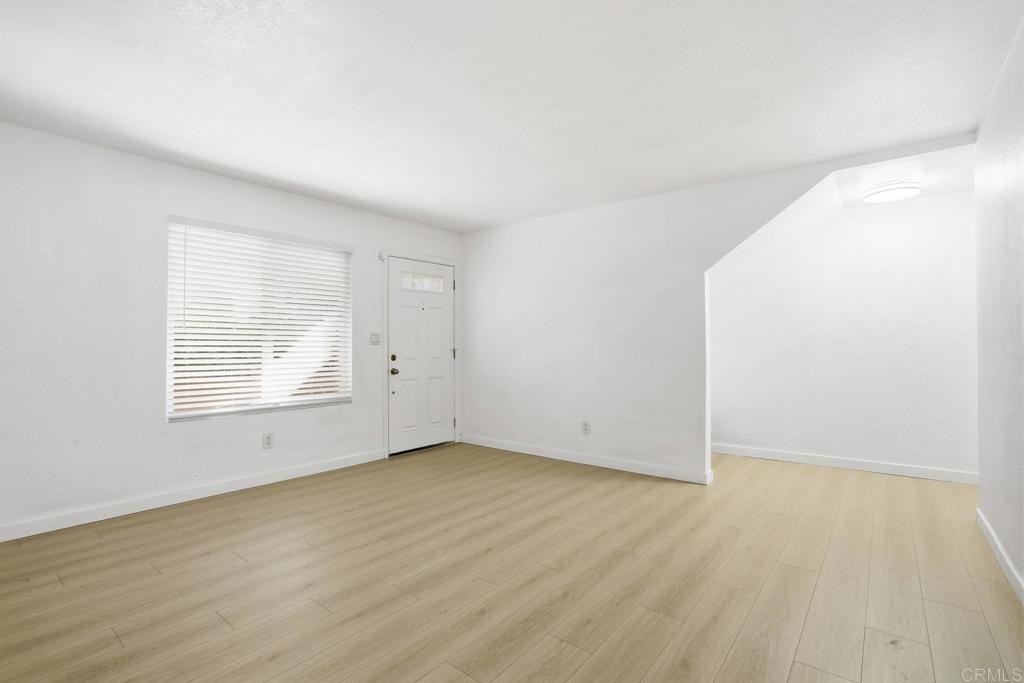 4455 Home Avenue, Unit 2 San Diego, CA 92105 - Photo 7 of 28 an empty room with wooden floor and windows