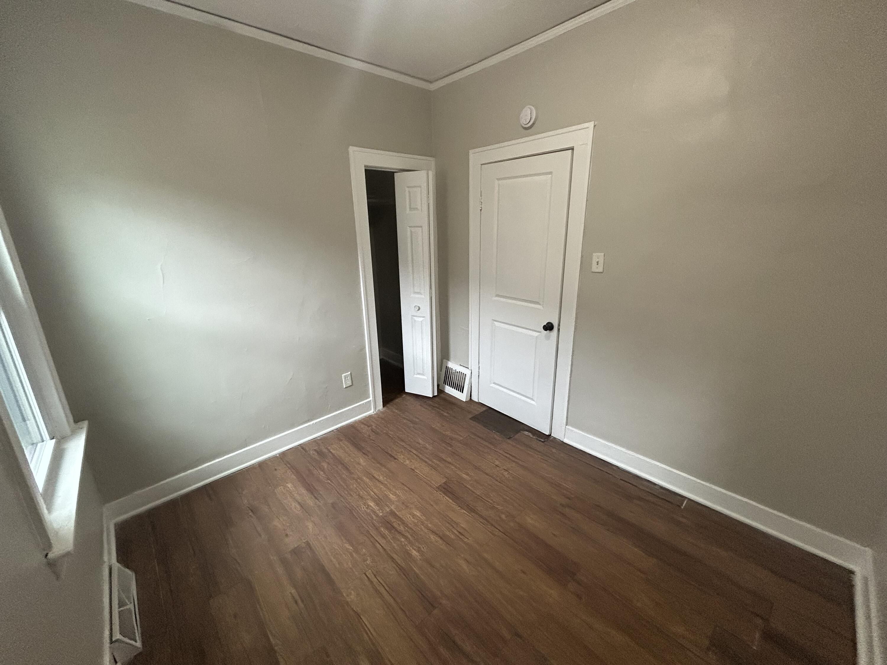 3661 Connecticut Street Gary, IN 46409 - Photo 14 of 17 an empty room with wooden floor and windows