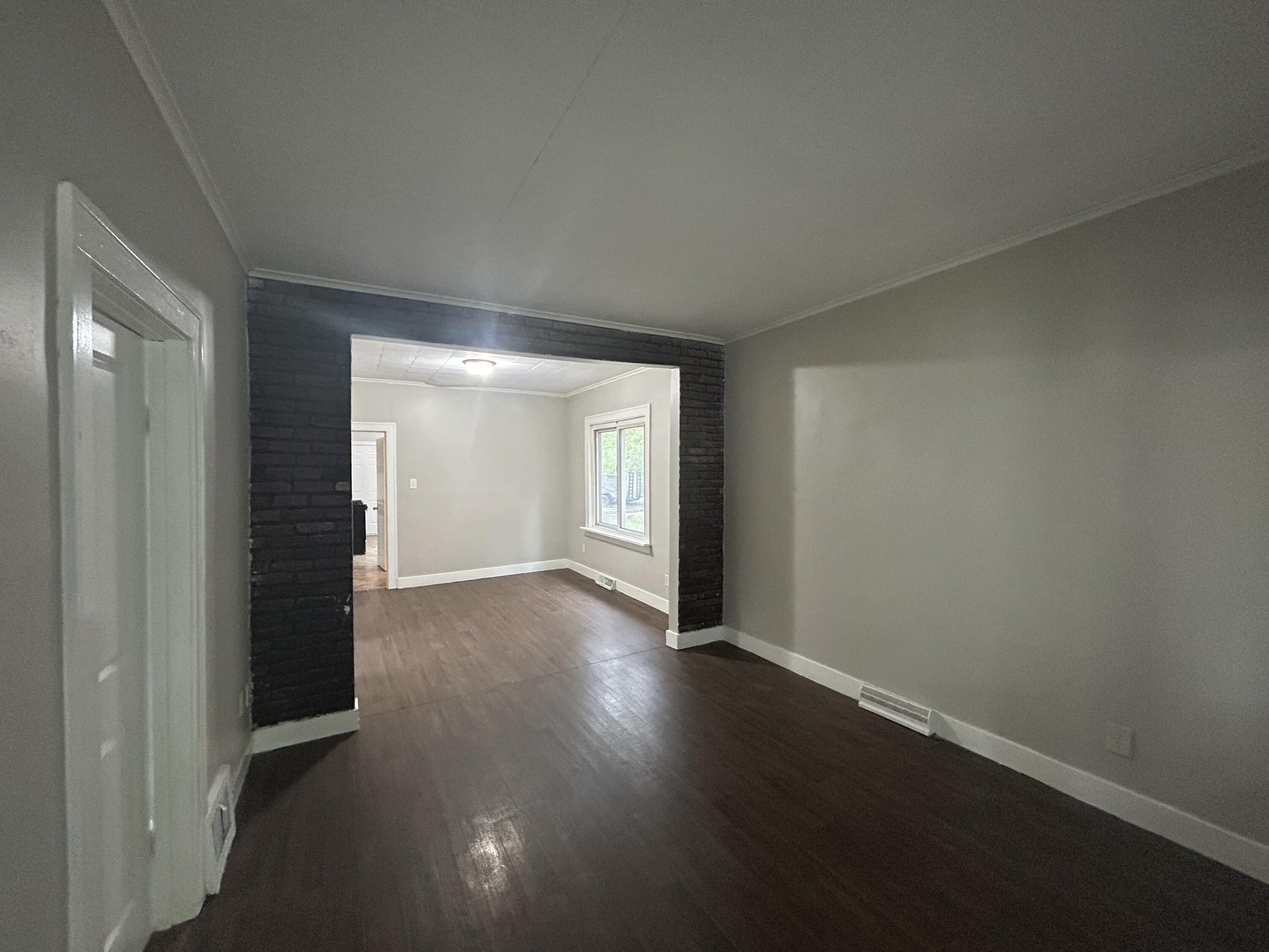 3661 Connecticut Street Gary, IN 46409 - Photo 15 of 17 an empty room with wooden floor and windows