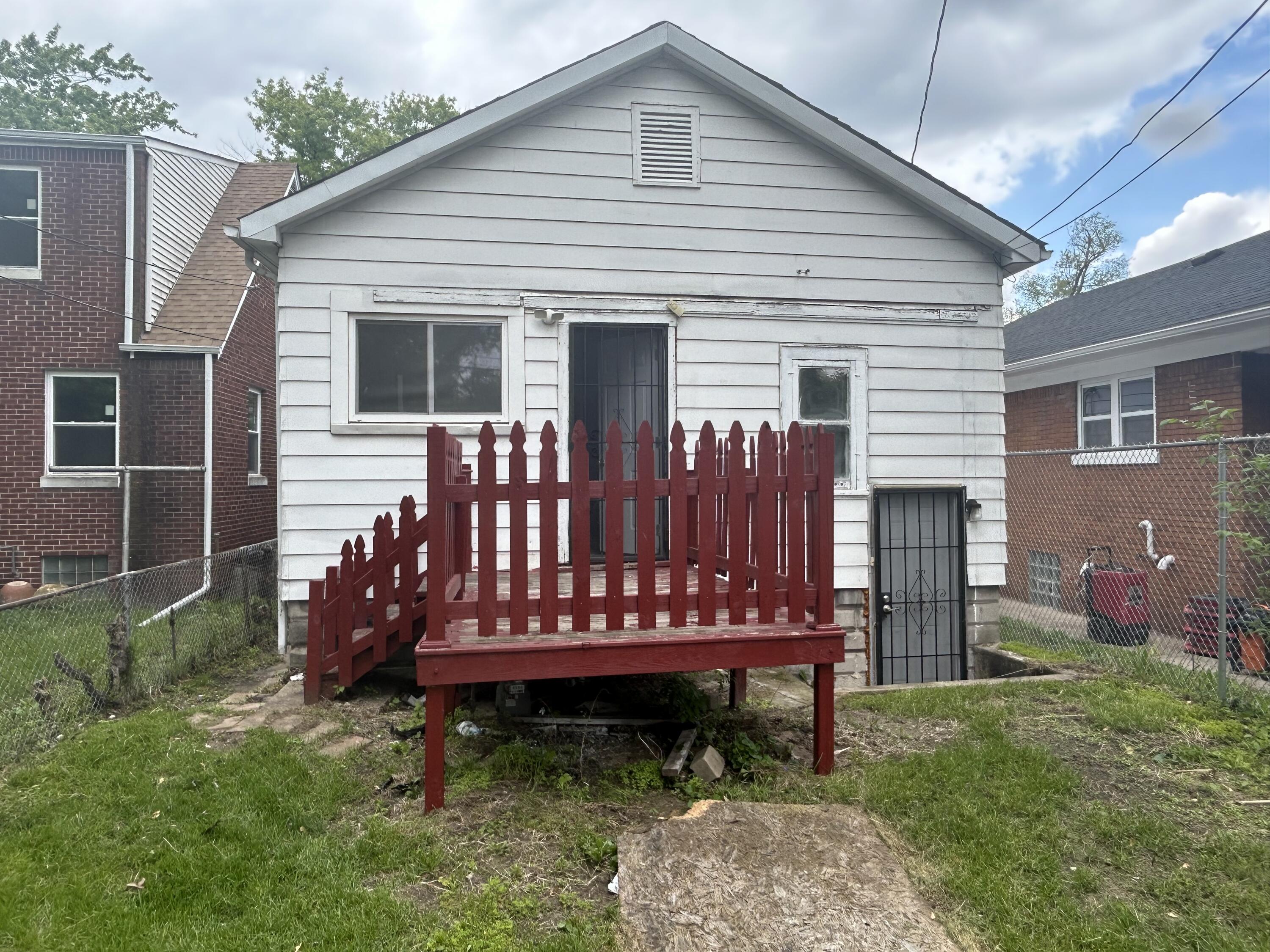 3661 Connecticut Street Gary, IN 46409 - Photo 2 of 17 a view of a house with a yard chairs and wooden fence