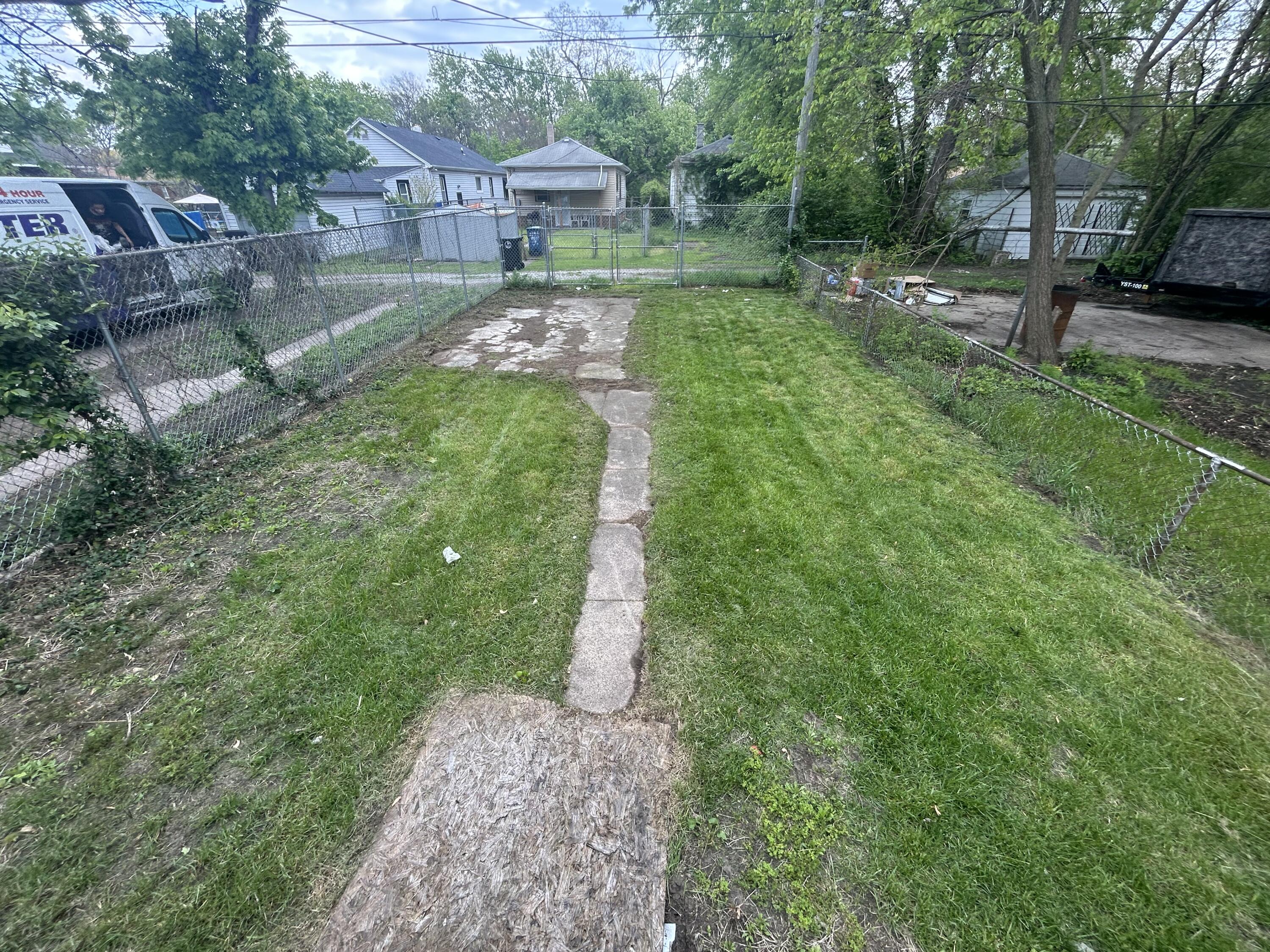 3661 Connecticut Street Gary, IN 46409 - Photo 3 of 17 a view of backyard with a garden and trees