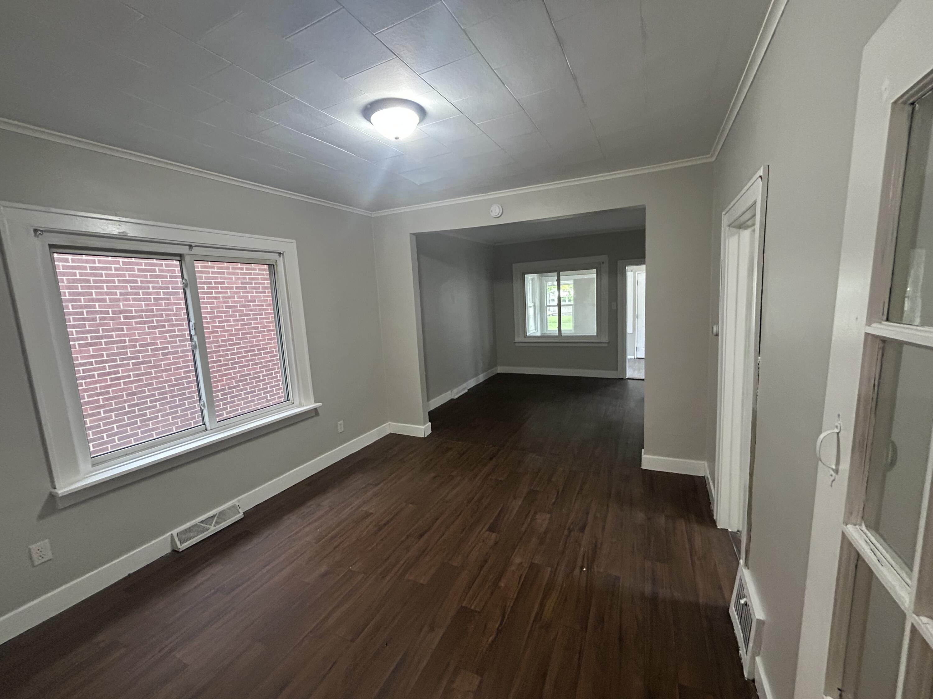 3661 Connecticut Street Gary, IN 46409 - Photo 10 of 17 a view of an empty room with wooden floor and a window