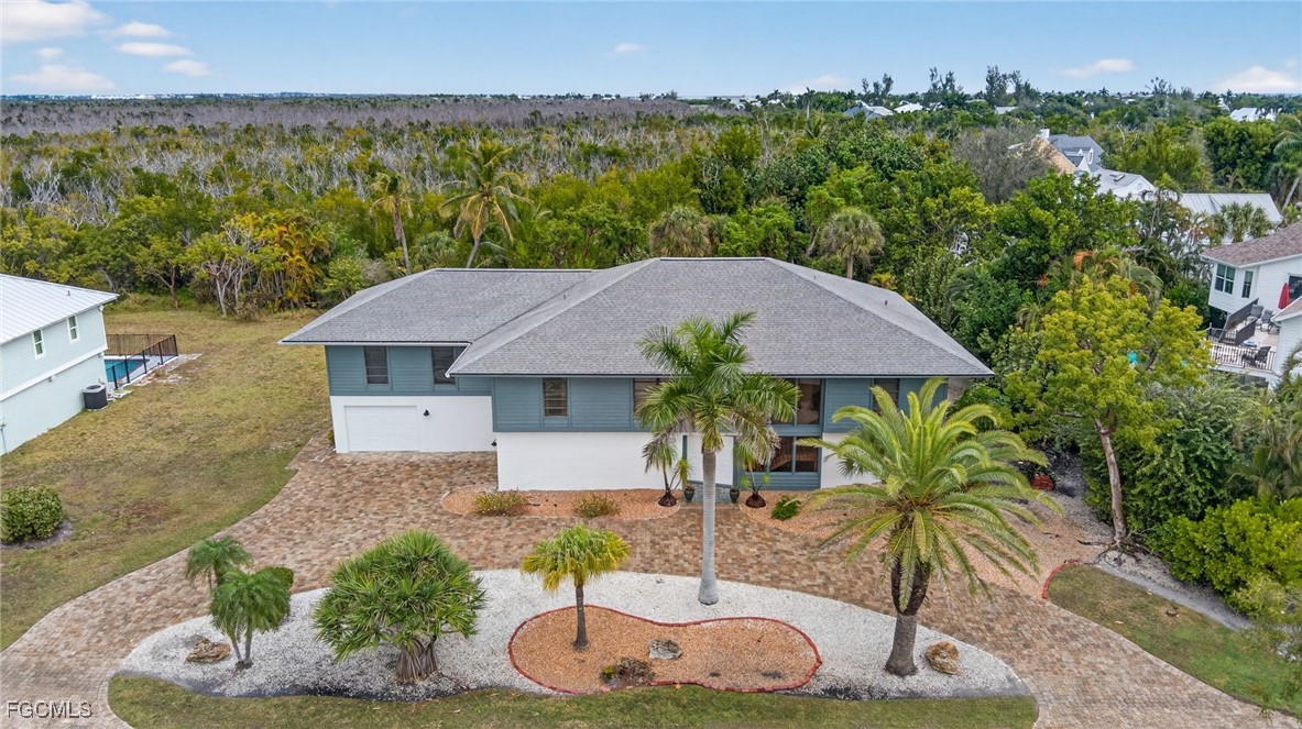an aerial view of a house with garden space and outdoor seating