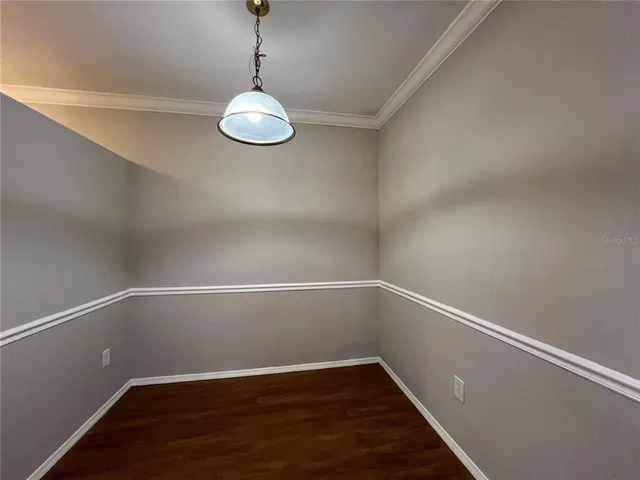 a view of a room with wooden floor and fan