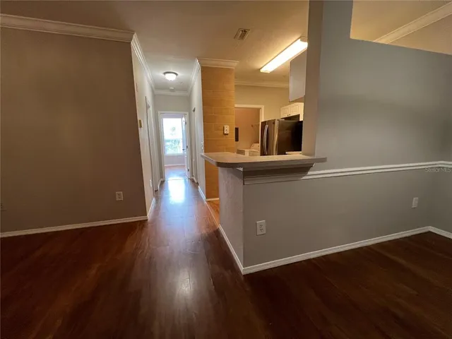 a view of a kitchen from the hallway