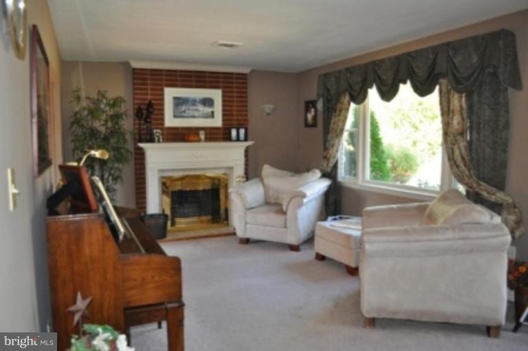 4807 Dave Rill Road Hampstead, MD 21074 - Photo 3 of 25 a living room with furniture a window and a fireplace