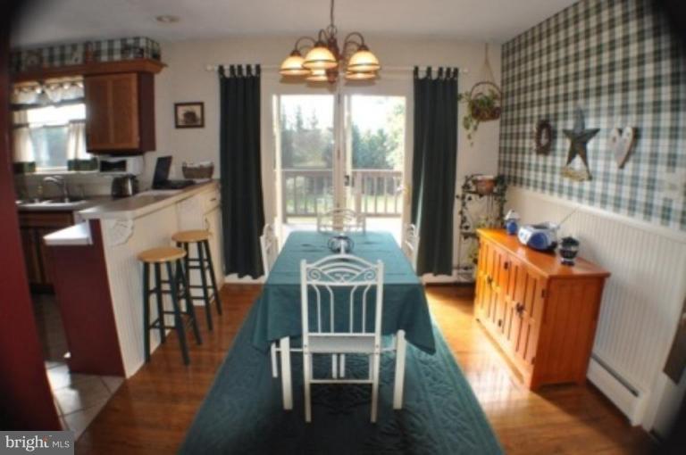 4807 Dave Rill Road Hampstead, MD 21074 - Photo 4 of 25 a view of a dining room with furniture window and wooden floor