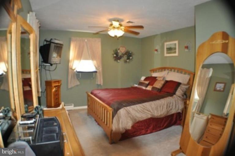 4807 Dave Rill Road Hampstead, MD 21074 - Photo 7 of 25 a bedroom with a bed and a chandelier