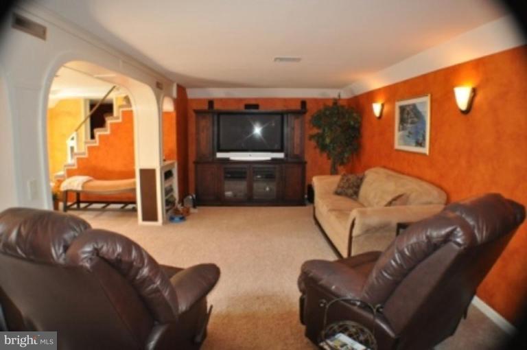 4807 Dave Rill Road Hampstead, MD 21074 - Photo 10 of 25 a living room with furniture and a flat screen tv