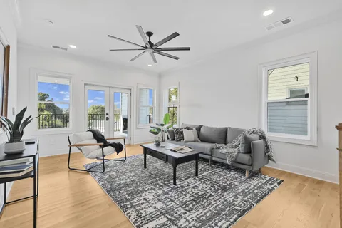 a living room with furniture and wooden floor