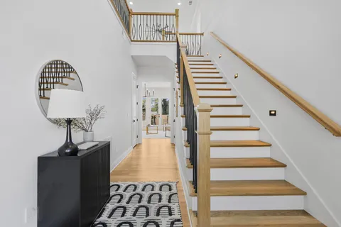 a view of entryway and hall with wooden floor