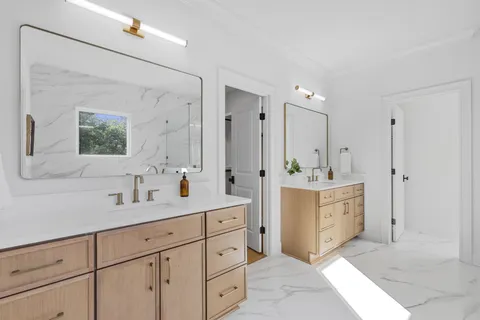a spacious bathroom with a double vanity sink mirror and double