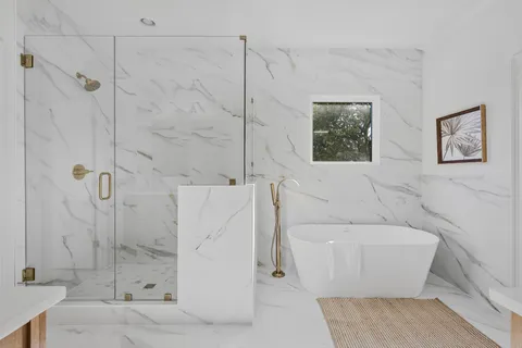 a bathroom with a toilet and a shower