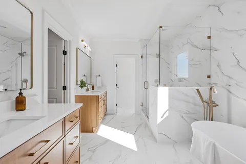 a bathroom with a double vanity sink toilet and shower