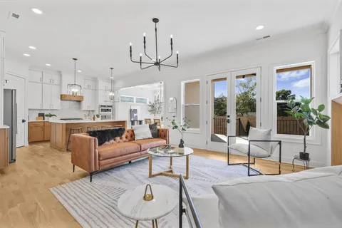 a living room with furniture or kitchen and a chandelier