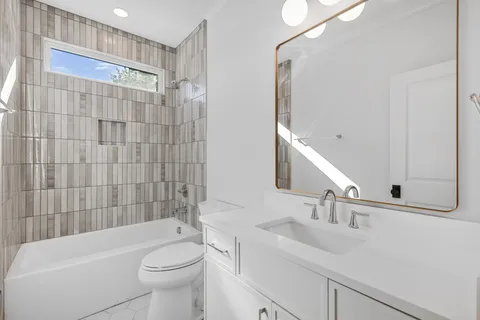 a bathroom with a bathtub and a toilet