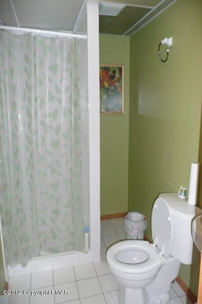 825 Hampstead Road Bushkill, PA 18324 - Photo 14 of 21 a white toilet sitting next to a bathroom sink and a shower