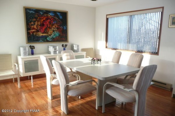 825 Hampstead Road Bushkill, PA 18324 - Photo 3 of 21 a view of a dining room with furniture wooden floor and a flat screen tv