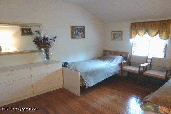 825 Hampstead Road Bushkill, PA 18324 - Photo 7 of 21 a bedroom with a bed and a couch