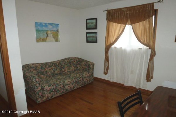 825 Hampstead Road Bushkill, PA 18324 - Photo 8 of 21 a living room with a bed and a window