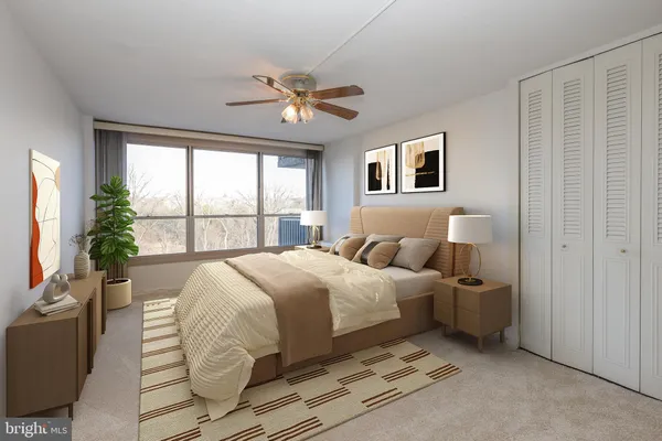 a bedroom with a large bed and a chandelier