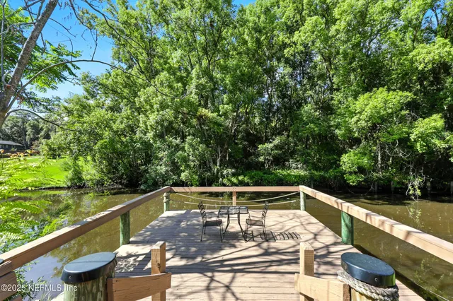 a view of a two chairs in the deck next to a yard