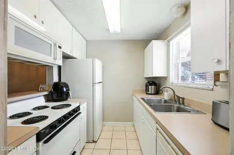 a kitchen that has a sink cabinets and a stove