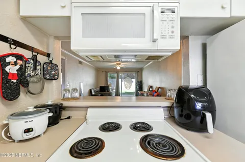 a kitchen with a sink a stove and a refrigerator