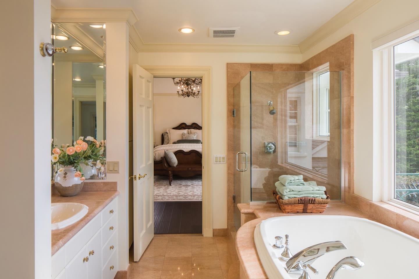 1476 Bonifacio Road Pebble Beach, CA 93953 - Photo 16 of 39 a spacious bathroom with a tub sink and mirror