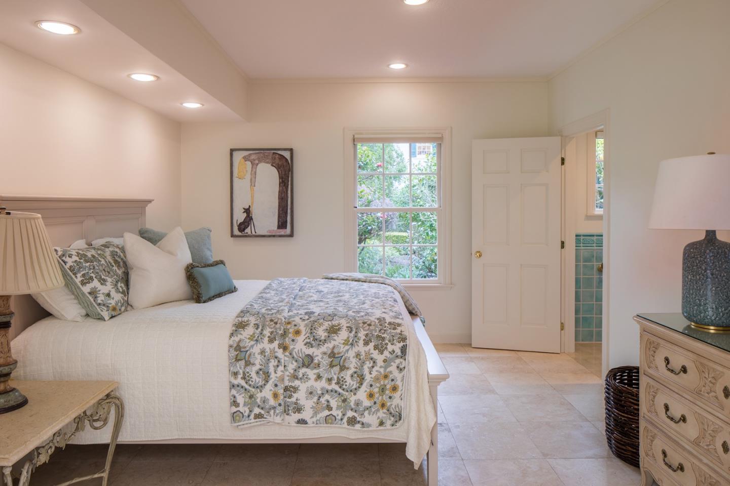 1476 Bonifacio Road Pebble Beach, CA 93953 - Photo 27 of 39 a bedroom with a large bed and a flat tv screen on dresser