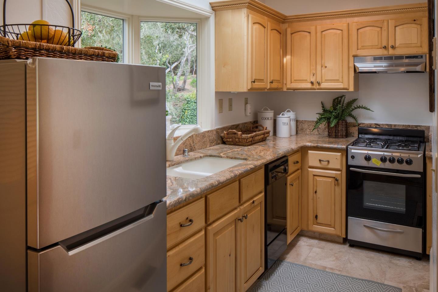 1476 Bonifacio Road Pebble Beach, CA 93953 - Photo 30 of 39 a kitchen with granite countertop a refrigerator stove and sink
