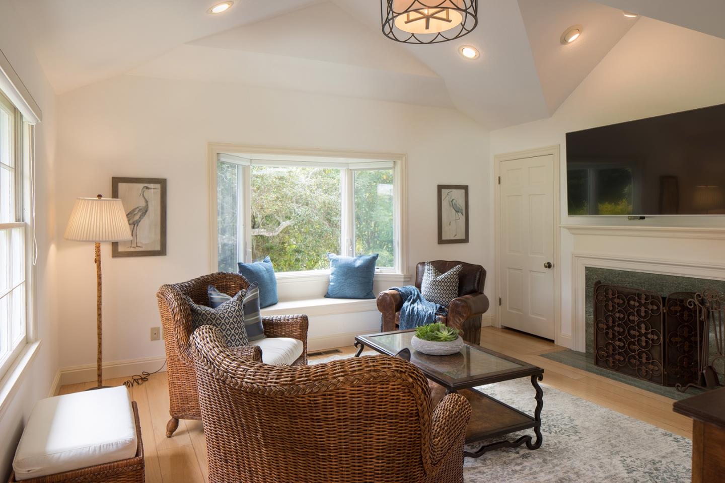 1476 Bonifacio Road Pebble Beach, CA 93953 - Photo 31 of 39 a living room with furniture a flat screen tv and a fireplace