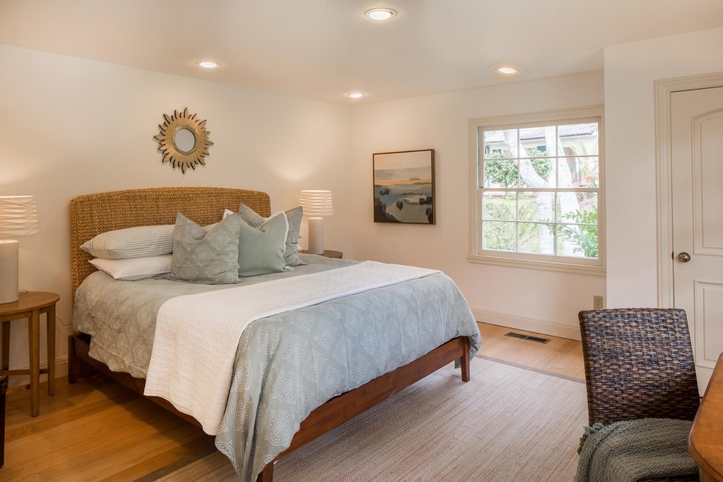 1476 Bonifacio Road Pebble Beach, CA 93953 - Photo 32 of 39 a bedroom with a bed and a chair