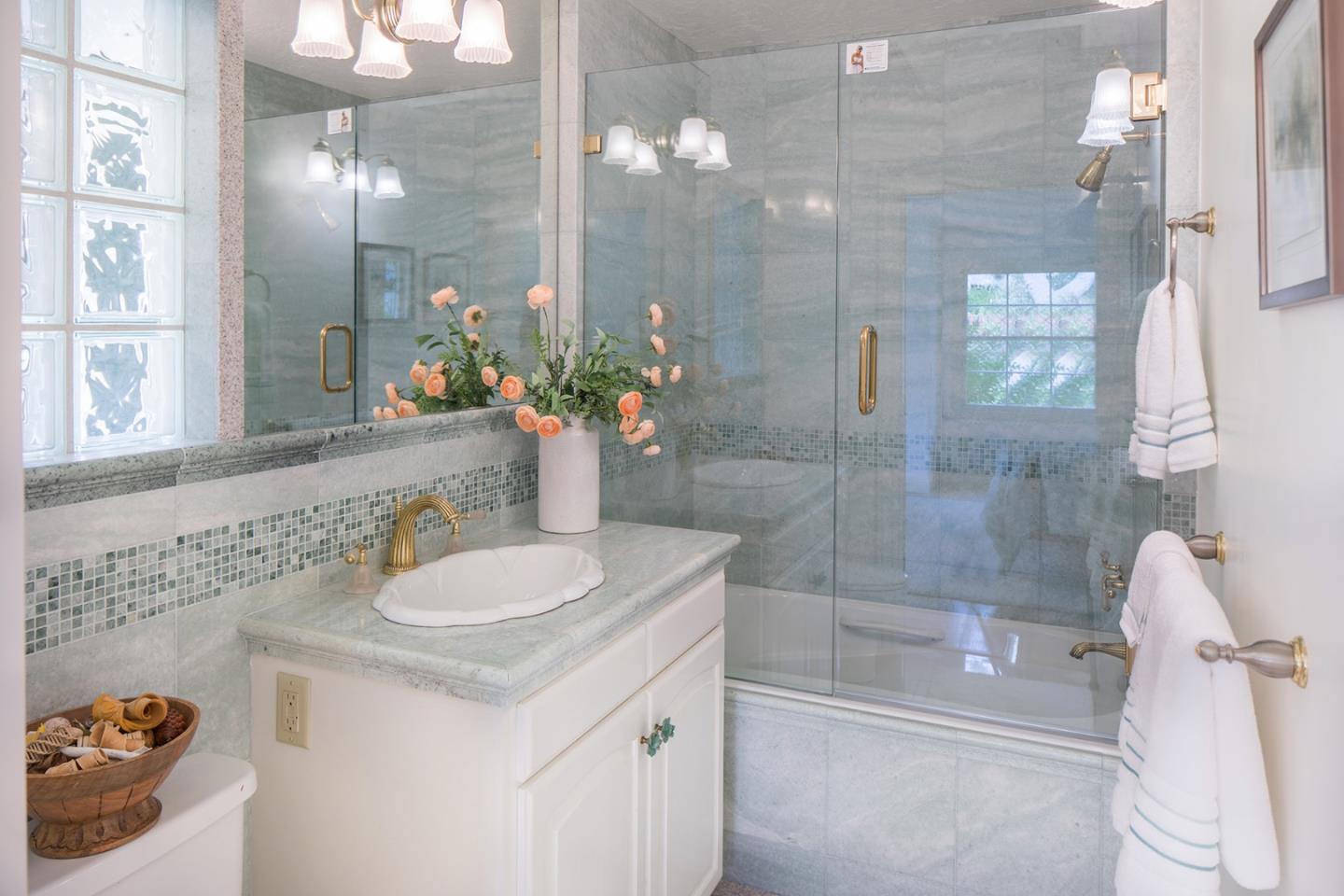 1476 Bonifacio Road Pebble Beach, CA 93953 - Photo 33 of 39 a bathroom with a granite countertop sink a toilet and shower