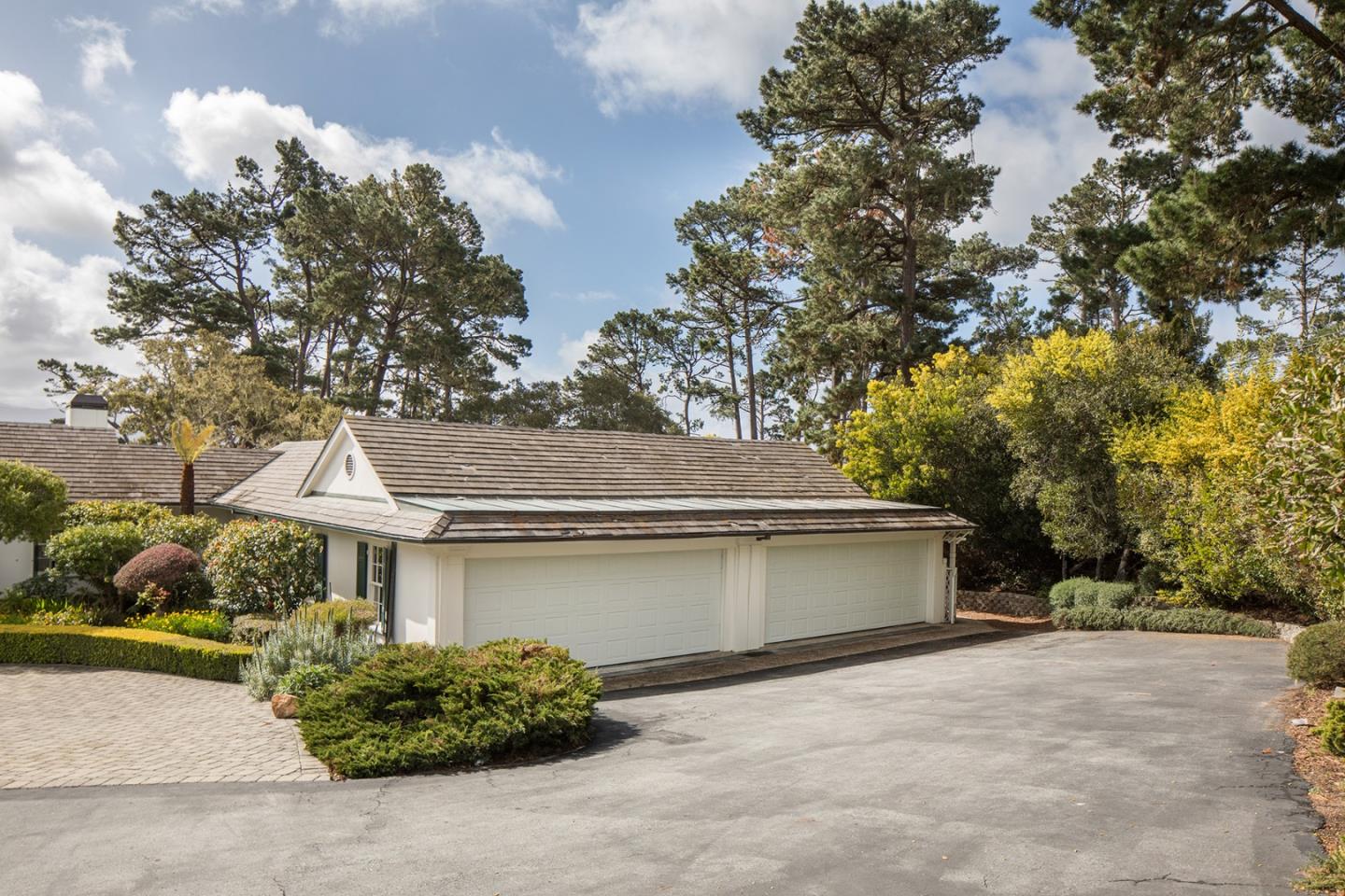 1476 Bonifacio Road Pebble Beach, CA 93953 - Photo 35 of 39 a front view of a house with a yard and garage
