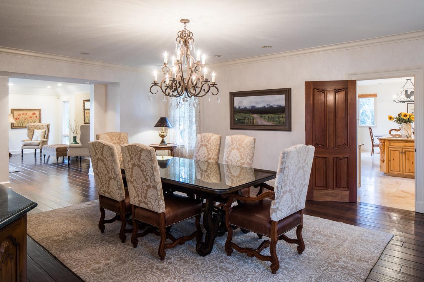 1476 Bonifacio Road Pebble Beach, CA 93953 - Photo 7 of 39 a view of a dining room with furniture a chandelier and wooden floor