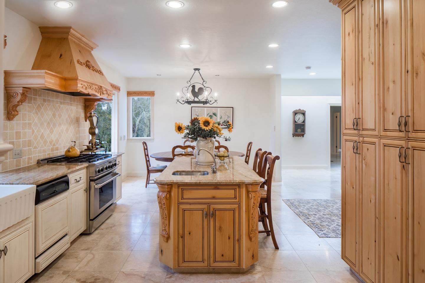 1476 Bonifacio Road Pebble Beach, CA 93953 - Photo 9 of 39 a kitchen with stainless steel appliances granite countertop a stove a sink and a refrigerator