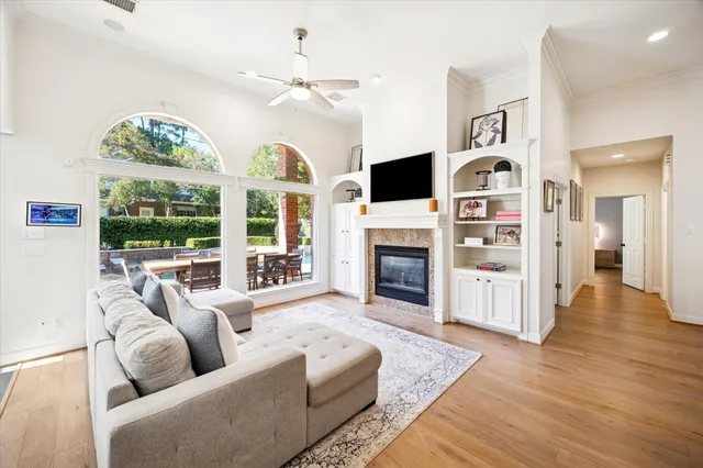 a living room with furniture fireplace and flat screen tv