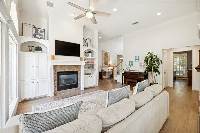 a living room with furniture a flat screen tv and a fireplace