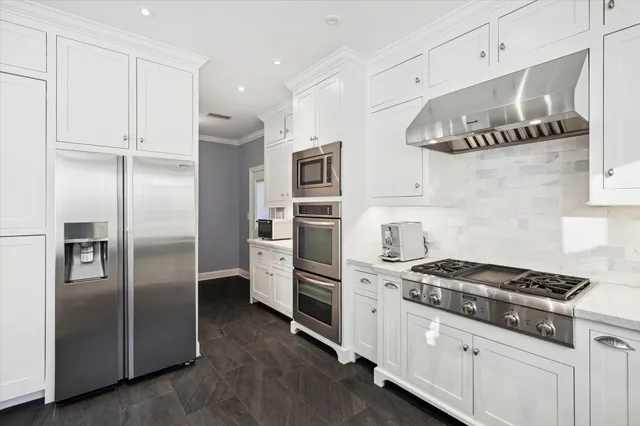 a kitchen with stainless steel appliances a refrigerator a sink and cabinets