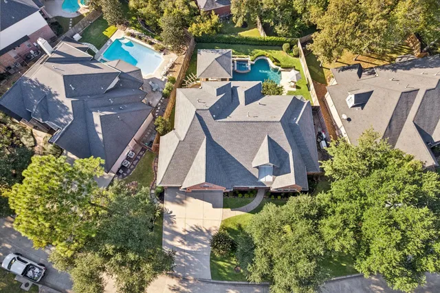 an aerial view of a house with garden space and street view