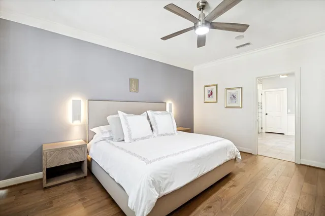 a bedroom with a bed and a ceiling fan