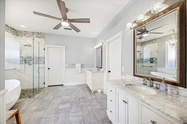 a large bathroom with a granite countertop sink a toilet a mirror and shower