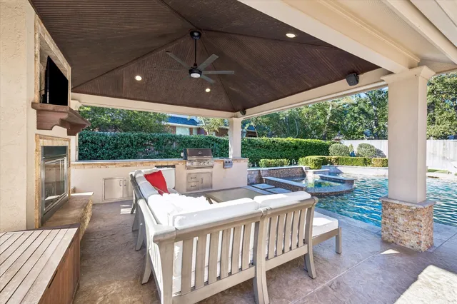 a view of a patio with a table chairs and a floor to ceiling window